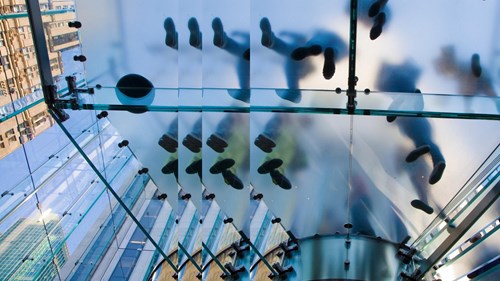 people on glass staris